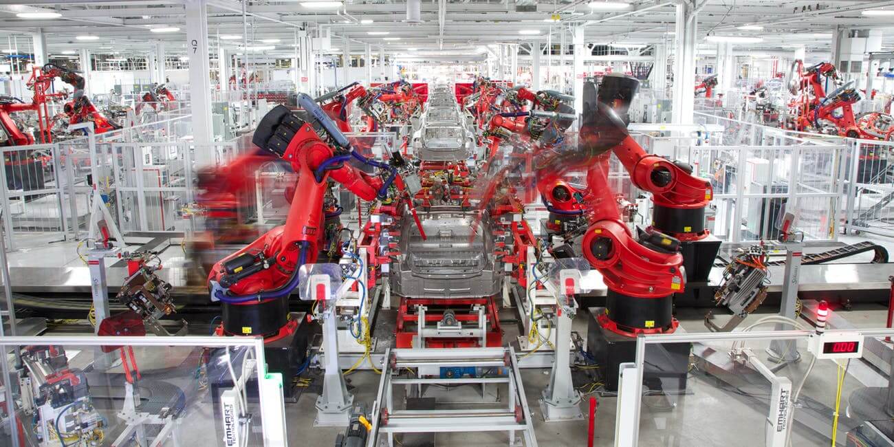 image showing a Tesla car being constructed on the factory production line